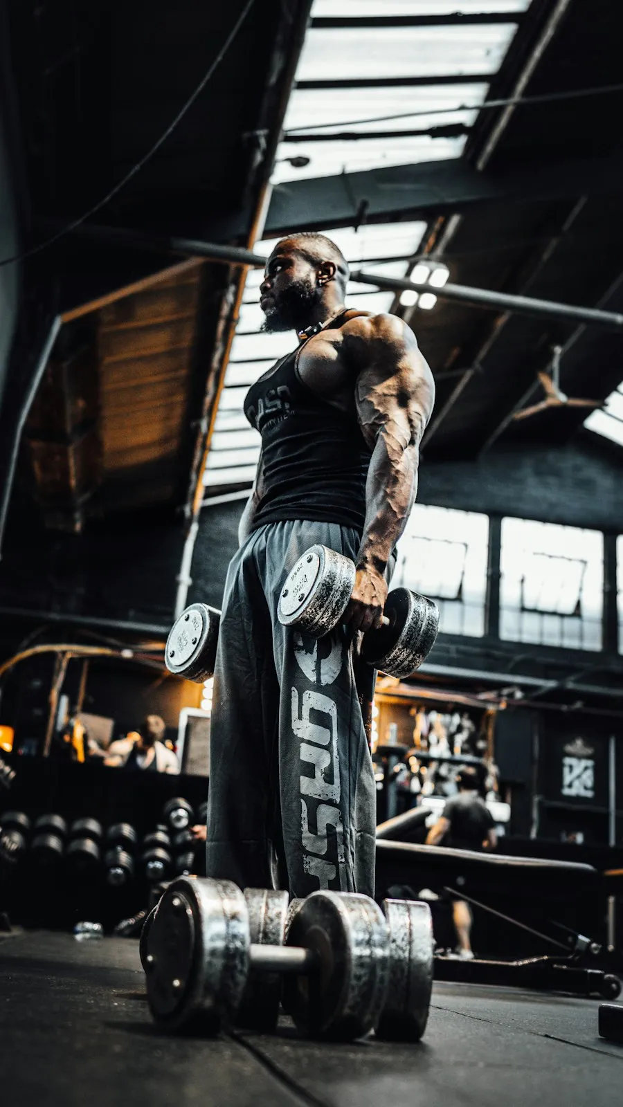 A coach holding a barbell in a gym